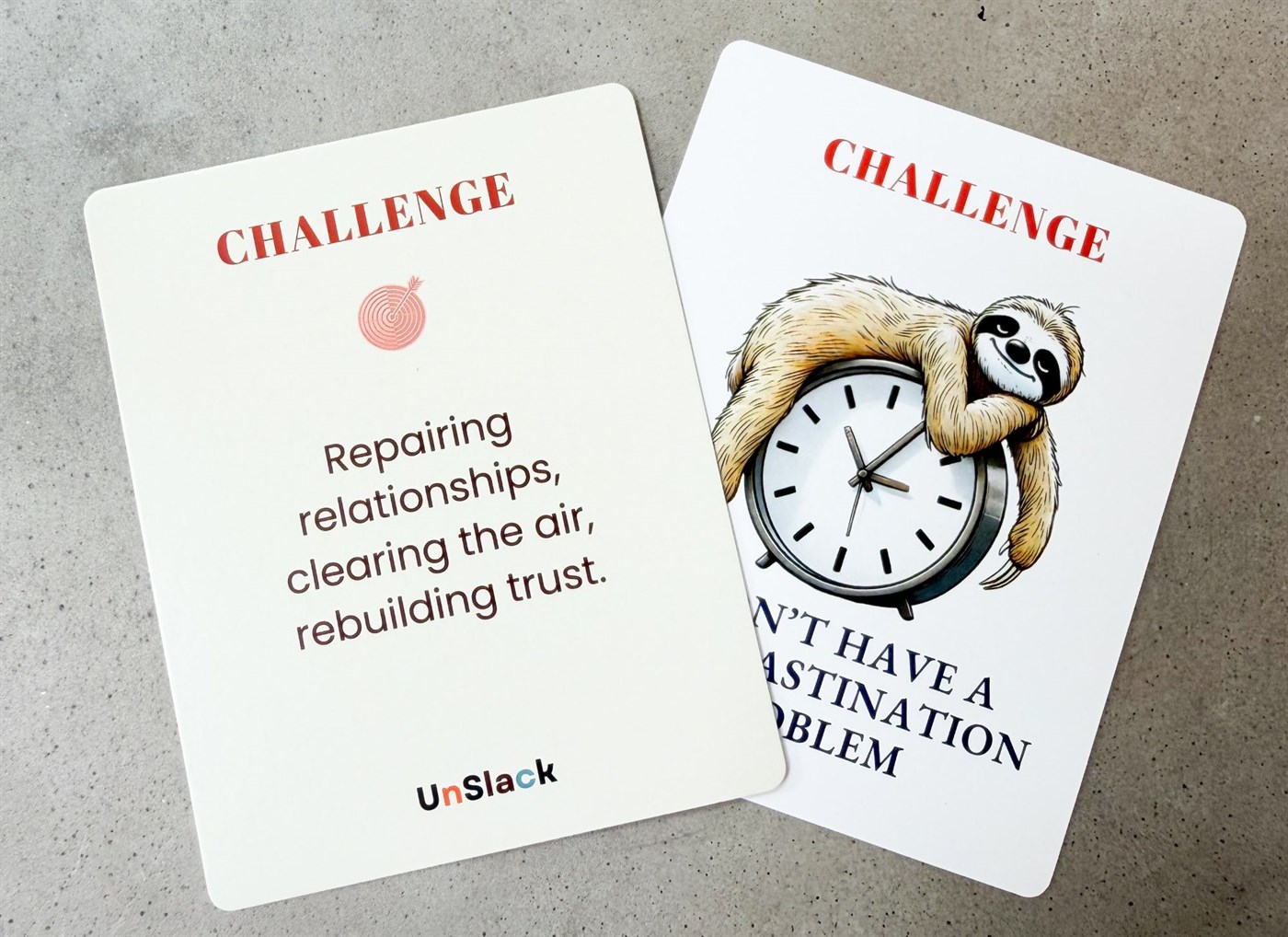 Two Unslack Challenge cards lying on a concrete surface